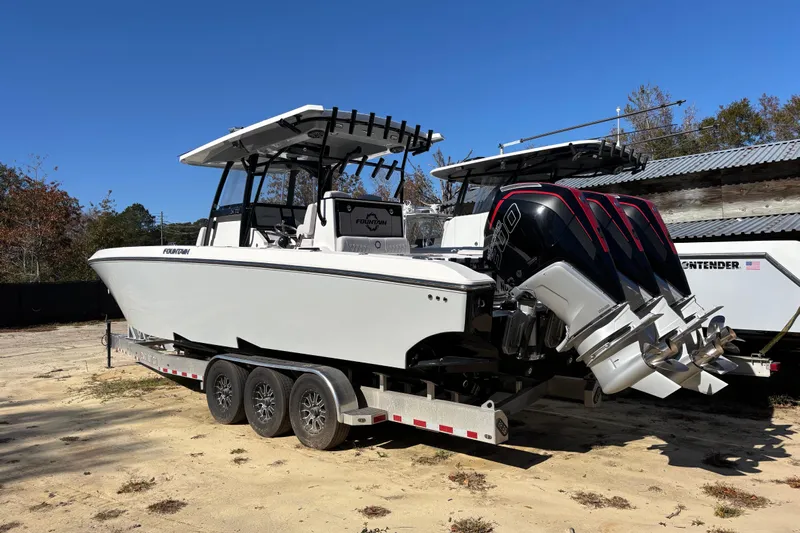  Yacht Photos Pics 2024 Fountain 34 Tournament Edition boat on trailer with triple outboard engines.