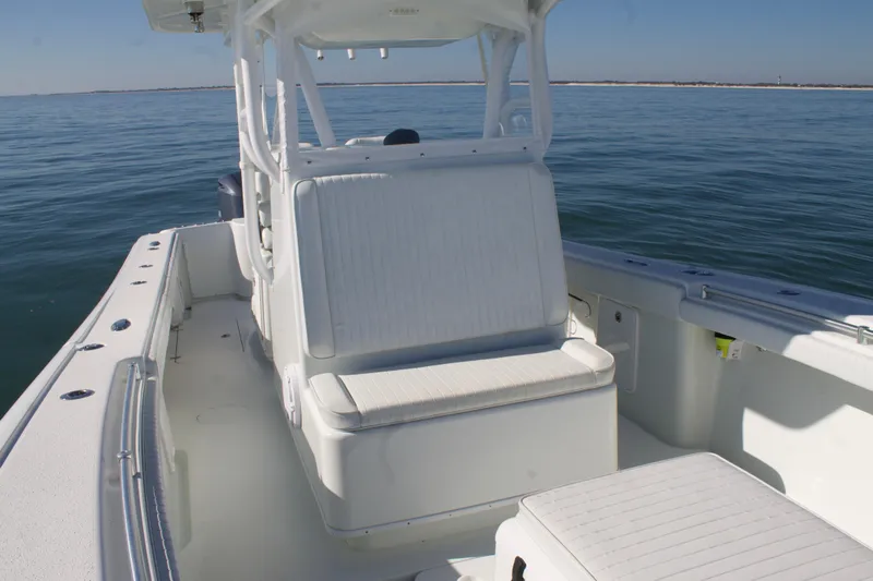  Yacht Photos Pics 2014 Yellowfin 32 Offshore boat interior with seating, on calm ocean waters.