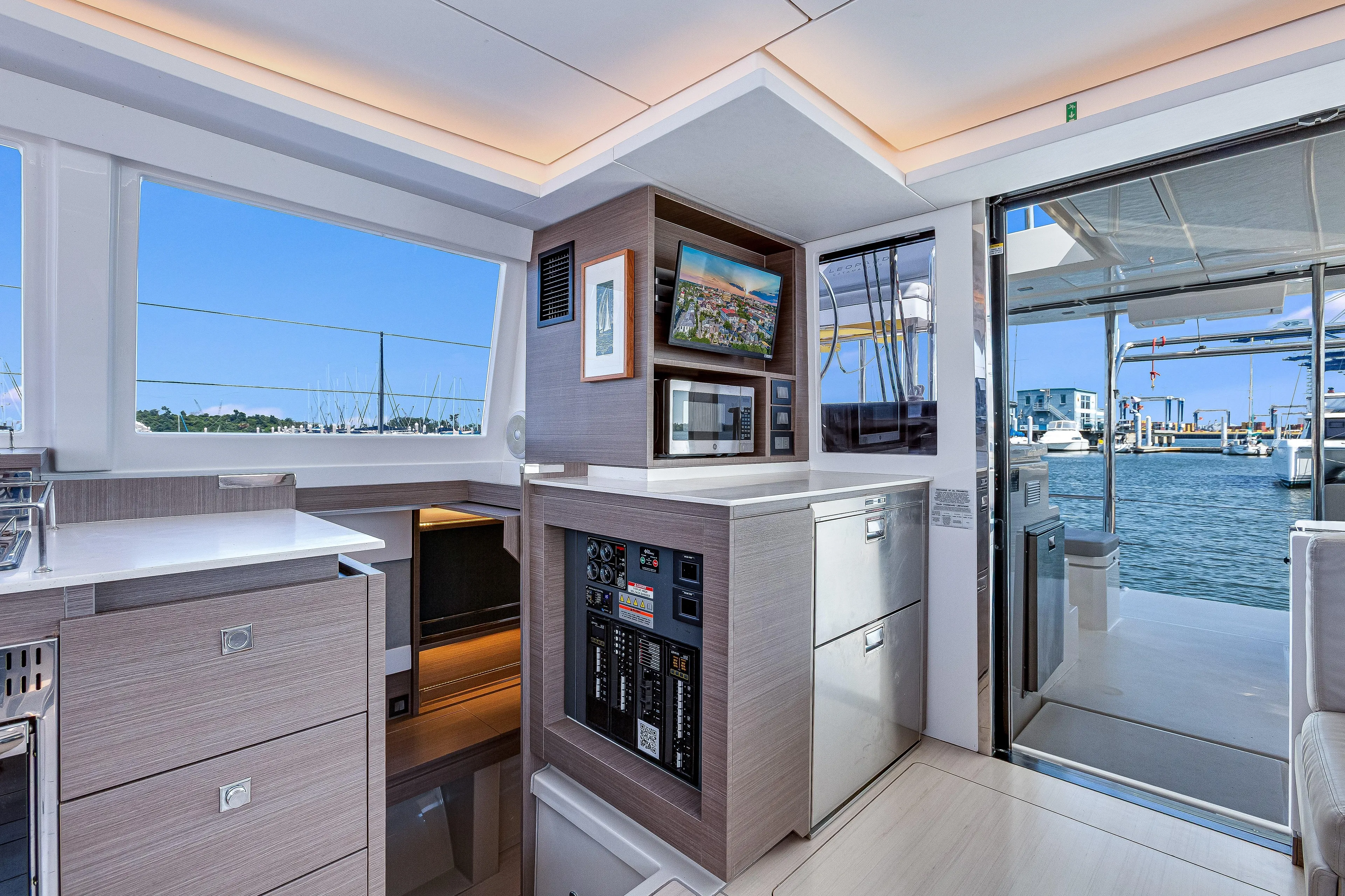 Limerick Yacht Photos Pics Luxurious interior of 2023 Leopard 42 yacht with modern kitchen and marina view.