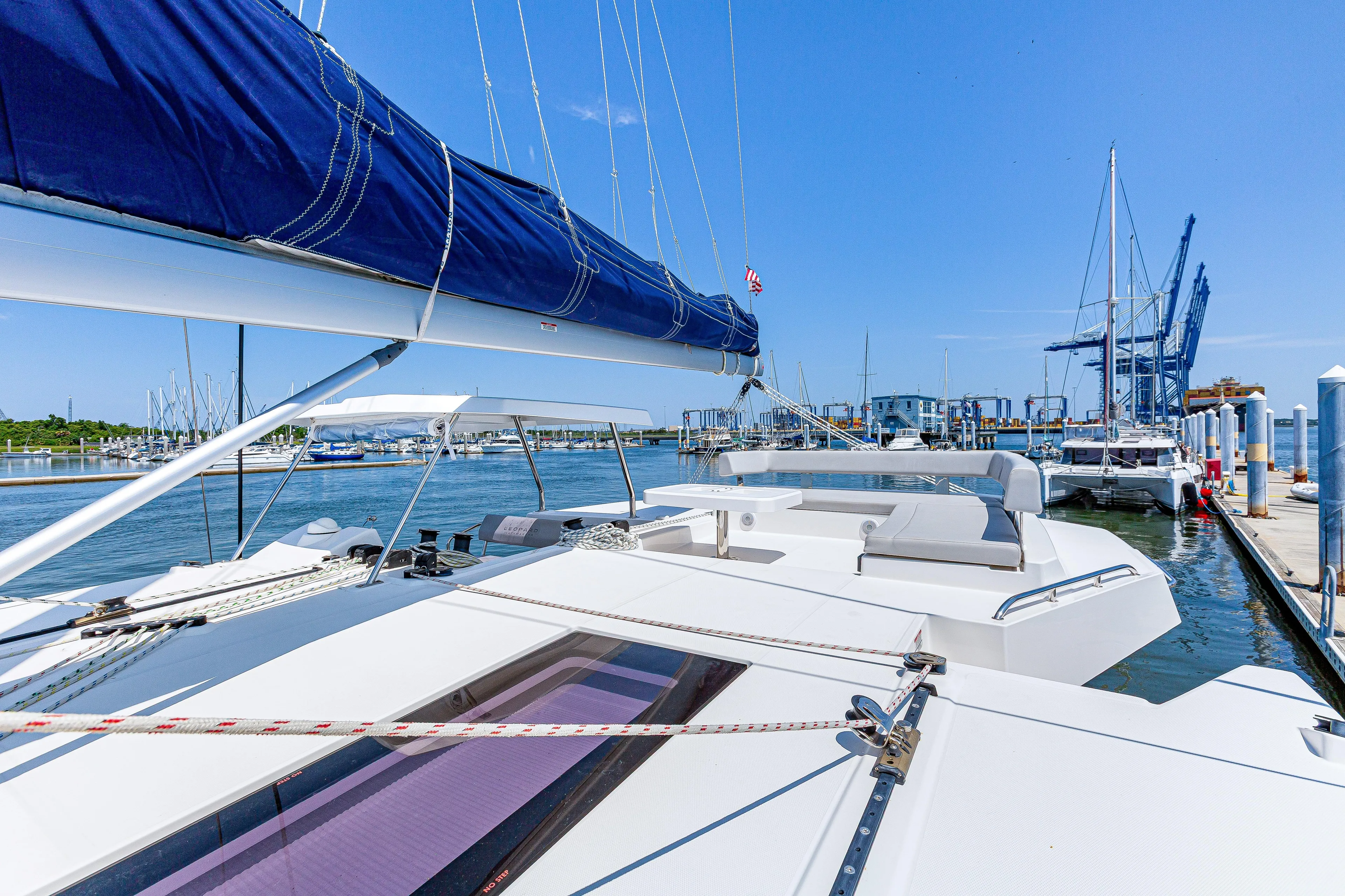 Limerick Yacht Photos Pics 2023 Leopard 42 catamaran docked at marina under clear blue sky.