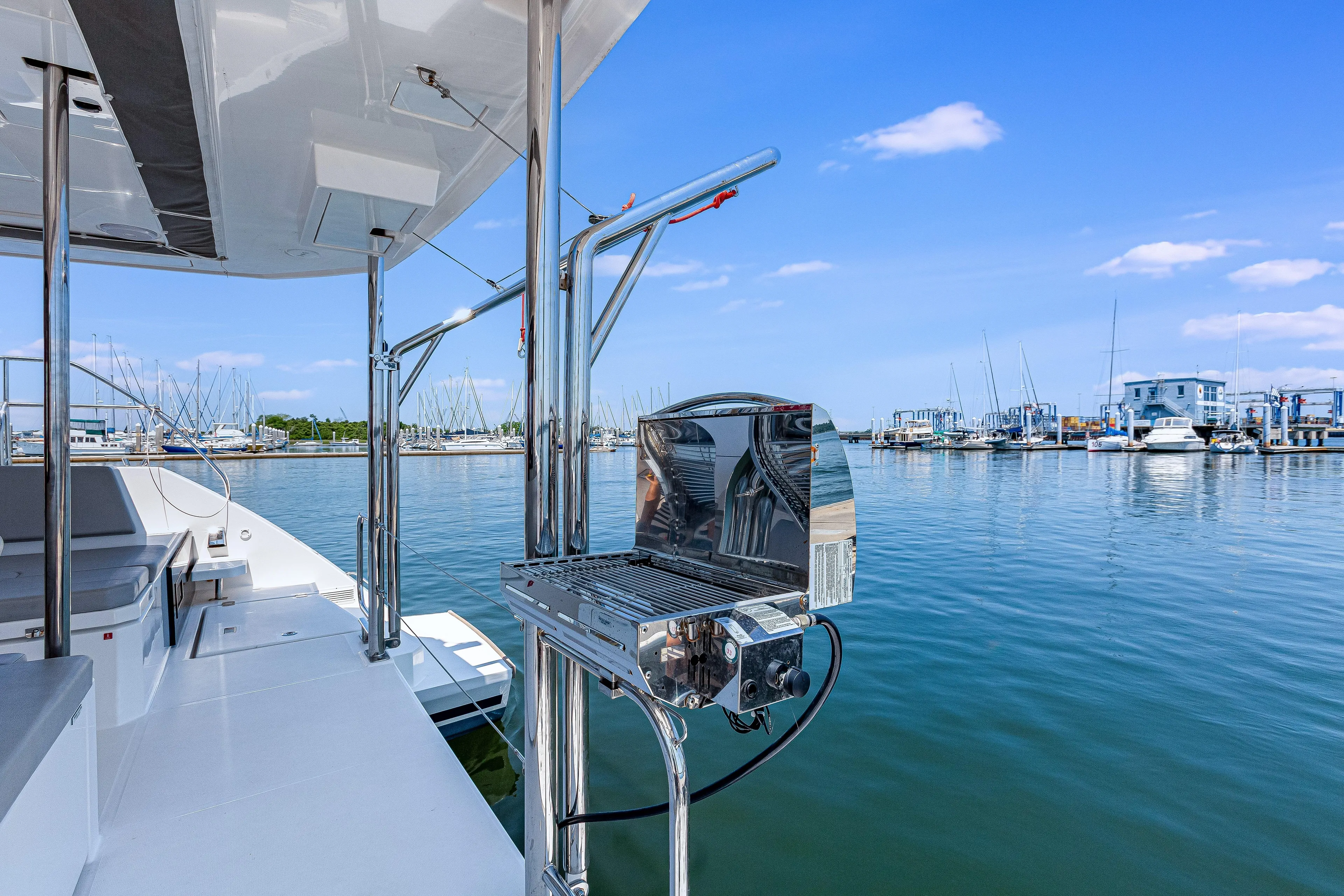 Limerick Yacht Photos Pics 2023 Leopard 42 yacht with grill, docked at marina under clear blue sky.