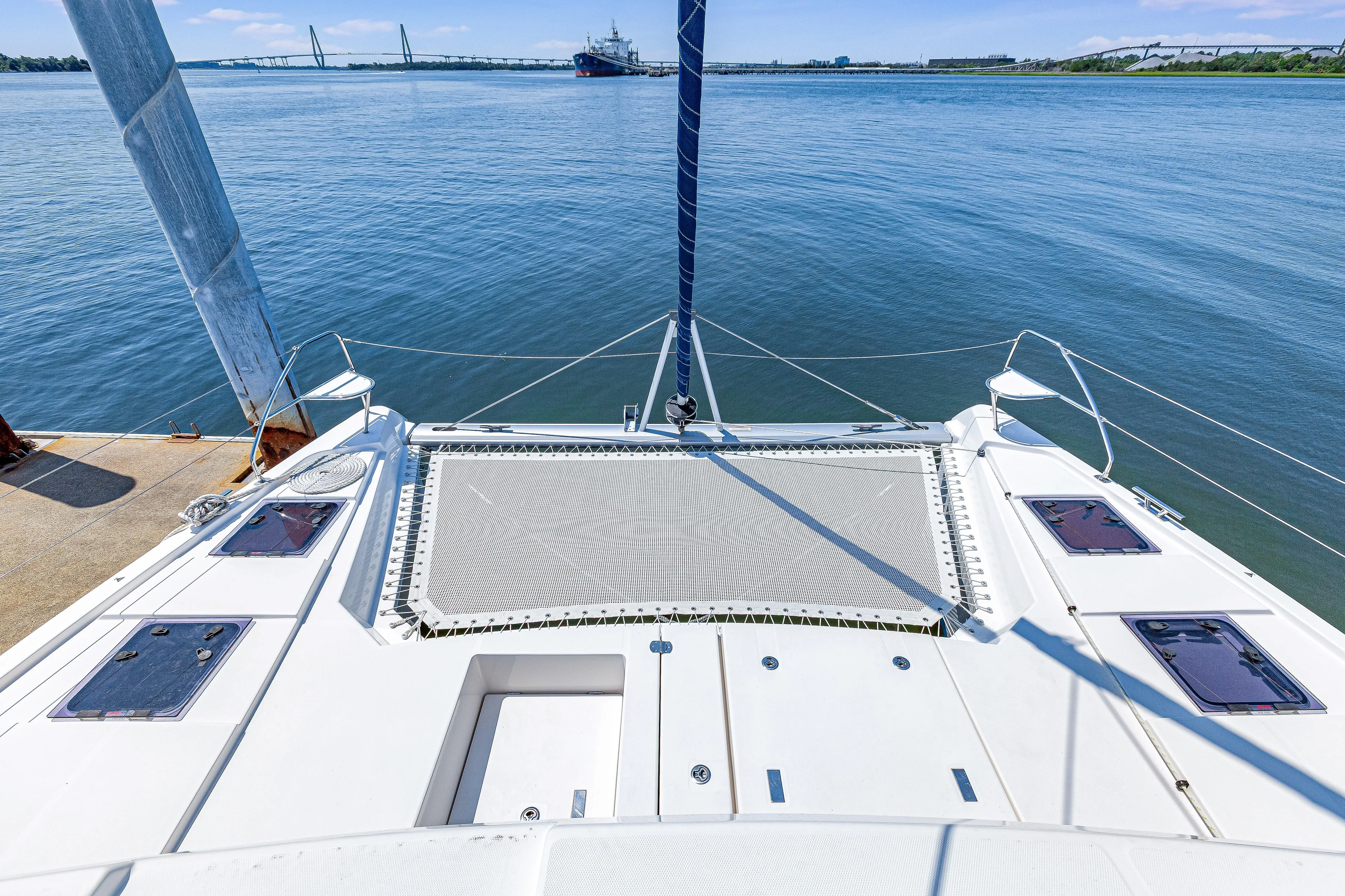 Limerick Yacht Photos Pics 2023 Leopard 42 catamaran on calm water with bridge and ship in background.