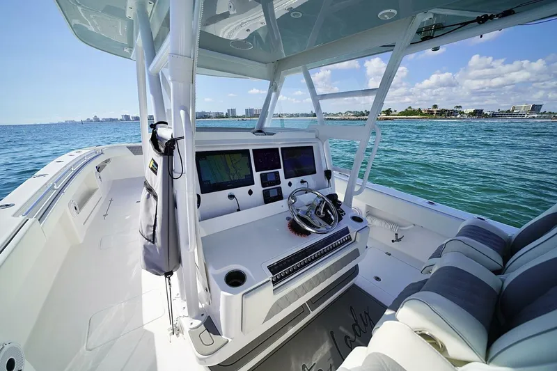 Little Lady Yacht Photos Pics 2024 Invincible 35 Catamaran cockpit with modern controls, steering wheel, and ocean view.