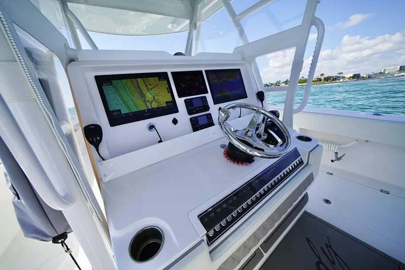 Little Lady Yacht Photos Pics 2024 Invincible 35 Catamaran helm with advanced navigation displays and steering wheel.