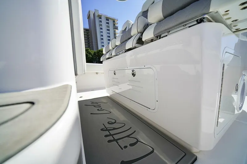 Little Lady Yacht Photos Pics 2024 Invincible 35 Catamaran interior with cushioned seating and storage compartment.