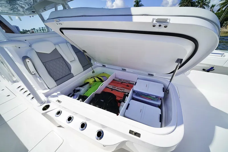 Little Lady Yacht Photos Pics 2024 Invincible 35 Catamaran storage compartment with life jackets and gear, open on deck.