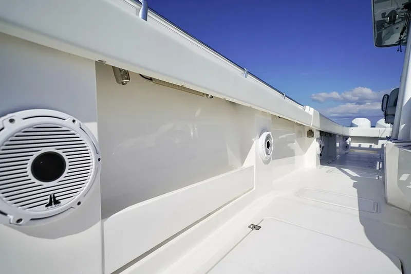 Little Lady Yacht Photos Pics 2024 Invincible 35 Catamaran deck with speakers and sleek design under blue sky.