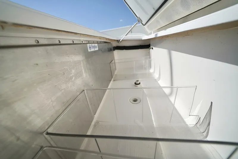 Little Lady Yacht Photos Pics 2024 Invincible 35 Catamaran storage compartment with open lid, showcasing interior space.