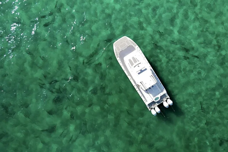 Little Lady Yacht Photos Pics Aerial view of 2024 Invincible 35 Catamaran on clear green water.