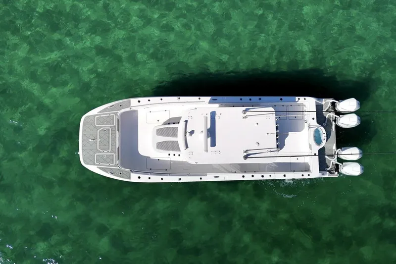 Little Lady Yacht Photos Pics Overhead view of 2024 Invincible 35 Catamaran on clear green water.