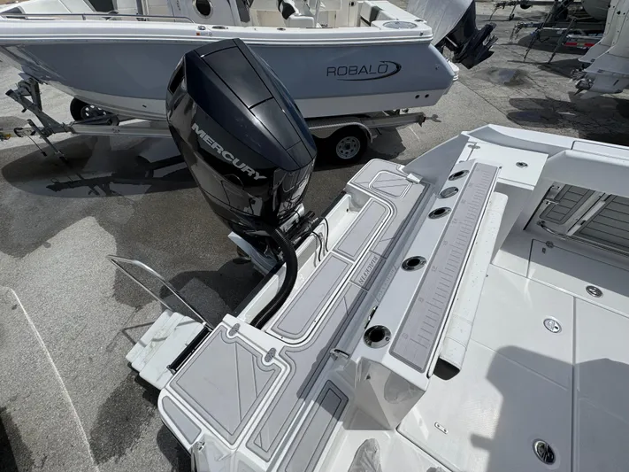 252 - 457 Yacht Photos Pics 2025 Blackfin 252 CC boat with Mercury engine, docked beside a Robalo boat.