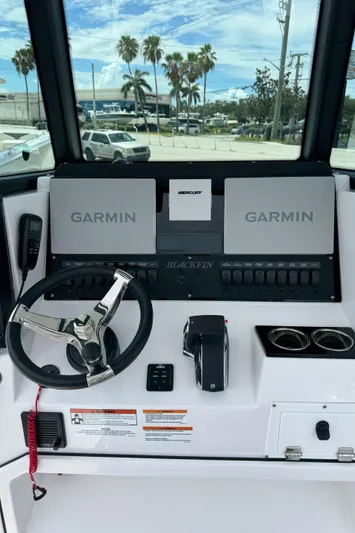252 - 457 Yacht Photos Pics 2025 Blackfin 252 CC boat dashboard with Garmin displays and Mercury controls.