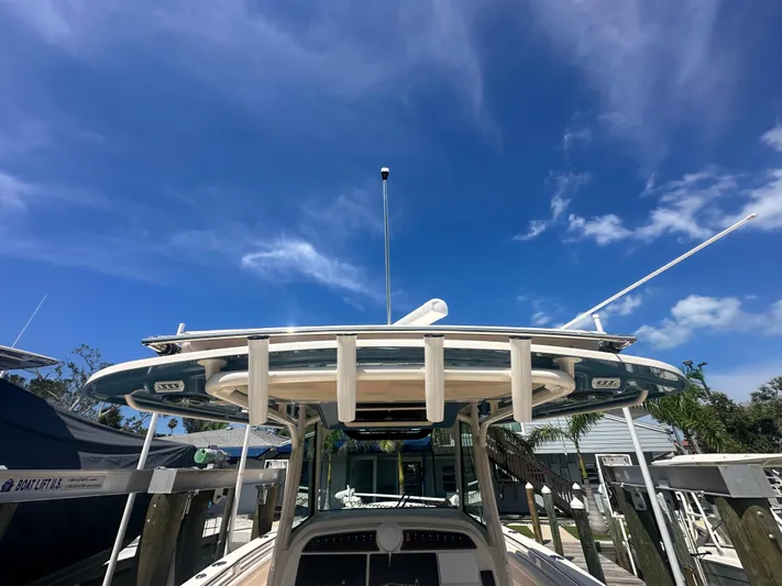 Sea-keeper/gen/ac/trolling Motor Yacht Photos Pics 2021 Grady-White Canyon 336 boat docked under clear blue sky.