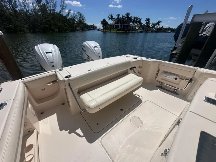 Sea-keeper/gen/ac/trolling Motor Yacht Photos Pics 2021 Grady-White Canyon 336 boat with dual engines, docked on a sunny day.