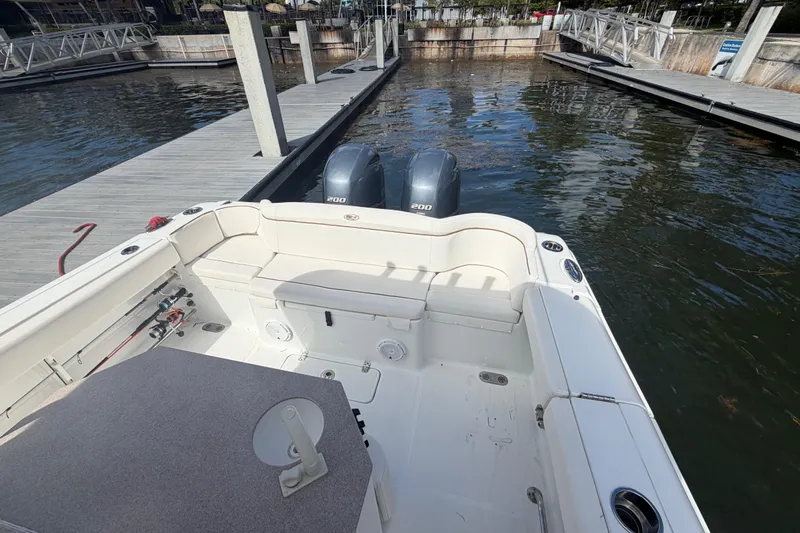  Yacht Photos Pics 2022 Sea Hunt Ultra 275 SE boat docked, featuring spacious seating and twin outboard engines.
