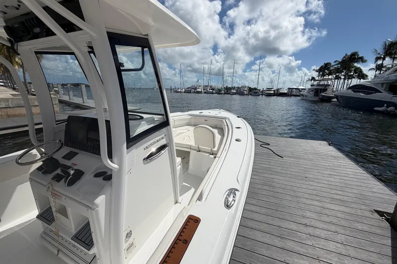  Yacht Photos Pics 2022 Sea Hunt Ultra 275 SE boat docked at marina under blue sky.