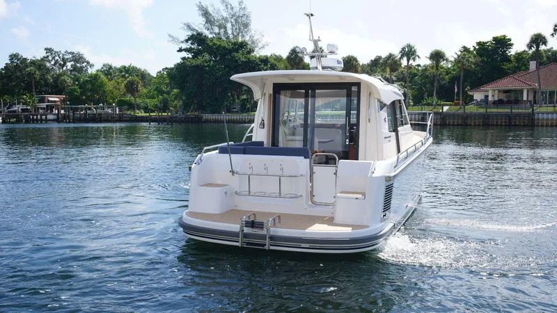 In-stock 2024 Nimbus 305 Coupé #393 Yacht Photos Pics 2024 Nimbus 305 Coupe #393 cruising on a serene lake.