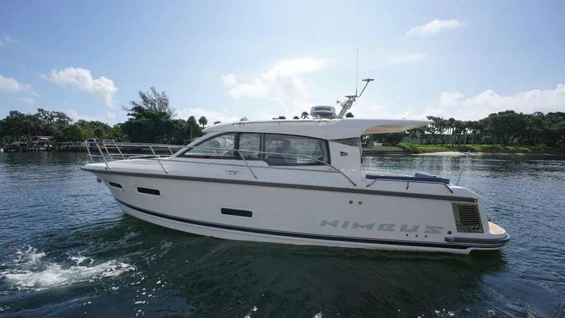 In-stock 2024 Nimbus 305 Coupé #393 Yacht Photos Pics 2024 Nimbus 305 Coupe #393 luxury motor yacht on a serene lake.