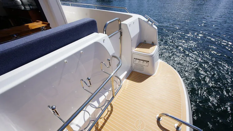 In-stock 2024 Nimbus 305 Coupé #393 Yacht Photos Pics 2024 Nimbus 305 Coupe #393 boat deck with seating and water view.