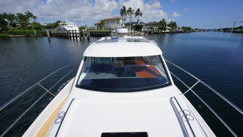 In-stock 2024 Nimbus 305 Coupé #393 Yacht Photos Pics 2024 Nimbus 305 Coupe #393 cruising on a scenic waterway.