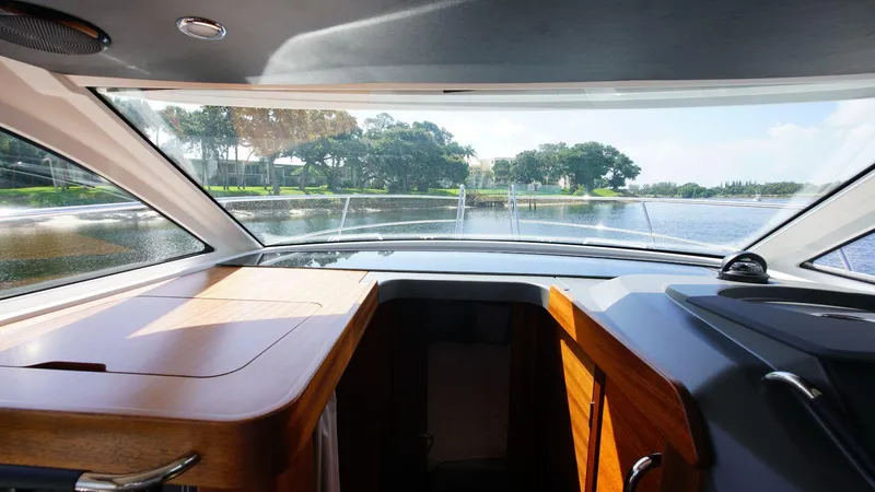 In-stock 2024 Nimbus 305 Coupé #393 Yacht Photos Pics Interior view of 2024 Nimbus 305 Coupe #393, showcasing the helm and panoramic windows.