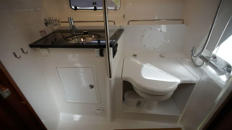 In-stock 2024 Nimbus 305 Coupé #393 Yacht Photos Pics 2024 Nimbus 305 Coupe #393 bathroom with sink, toilet, and shower.