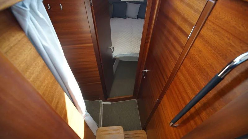 In-stock 2024 Nimbus 305 Coupé #393 Yacht Photos Pics Interior cabin view of 2024 Nimbus 305 Coupe #393, showing wooden finish and cozy bedroom.