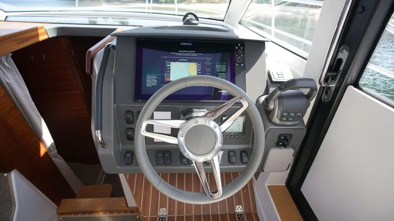 In-stock 2024 Nimbus 305 Coupé #393 Yacht Photos Pics Steering console of 2024 Nimbus 305 Coupe #393 with navigation display.