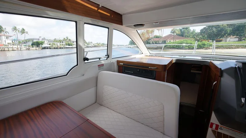 In-stock 2024 Nimbus 305 Coupé #393 Yacht Photos Pics Interior of 2024 Nimbus 305 Coupe #393, featuring a cozy seating area with waterfront views.