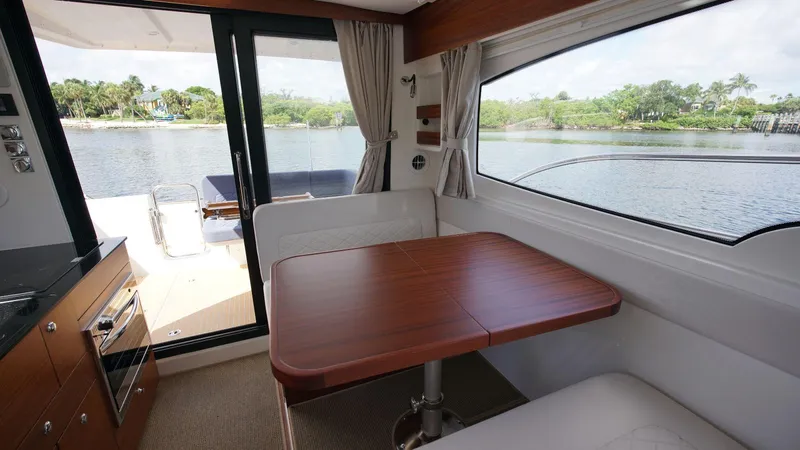 In-stock 2024 Nimbus 305 Coupé #393 Yacht Photos Pics Interior of 2024 Nimbus 305 Coupe #393 with dining table and scenic water view.