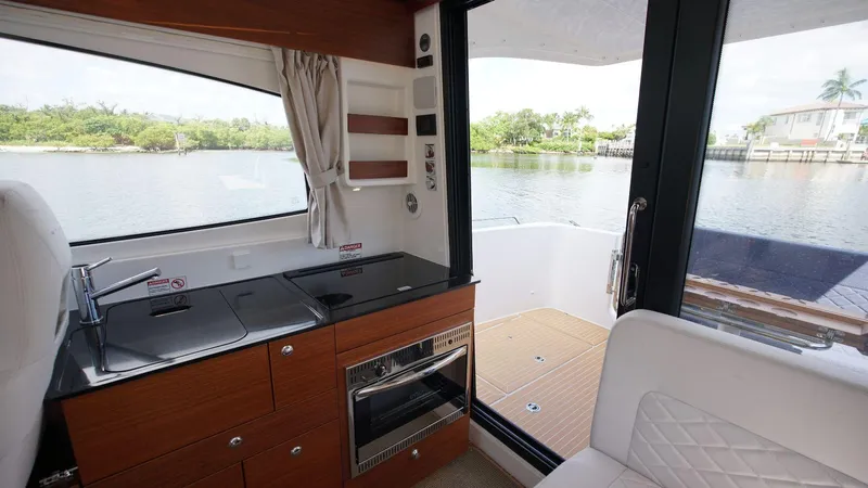 In-stock 2024 Nimbus 305 Coupé #393 Yacht Photos Pics Interior of 2024 Nimbus 305 Coupe #393 with kitchen and water view.