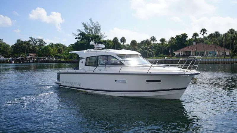 In-stock 2024 Nimbus 305 Coupé #393 Yacht Photos Pics 2024 Nimbus 305 Coupe #393 cruising on a serene waterway.