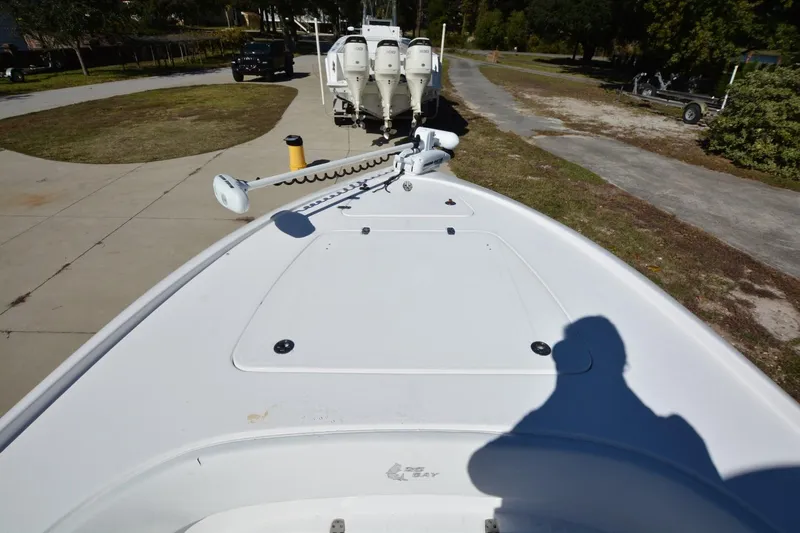 Hot Hooks II Yacht Photos Pics 2013 Contender 25 Bay boat with trolling motor, parked on a driveway.