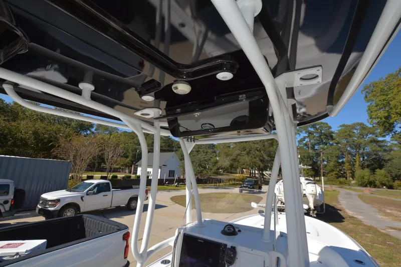 Hot Hooks II Yacht Photos Pics 2013 Contender 25 Bay boat with T-top and console, parked outdoors.