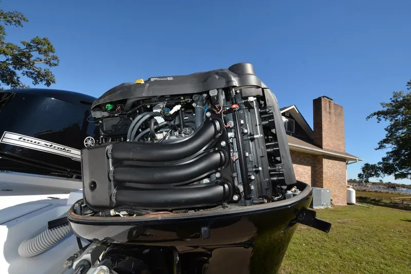 Hot Hooks II Yacht Photos Pics 2013 Contender 25 Bay boat with Yamaha four-stroke engine, open cover, outdoor setting.