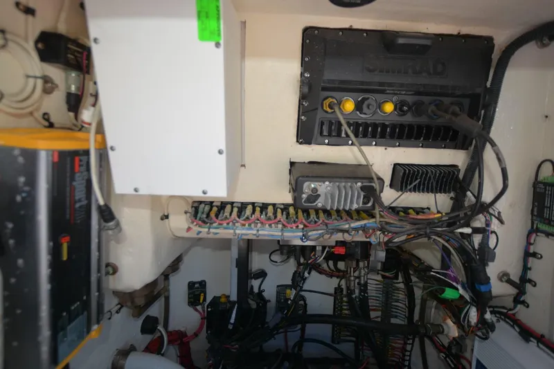 Hot Hooks II Yacht Photos Pics Electrical system inside a 2013 Contender 25 Bay boat, featuring wiring and control panels.