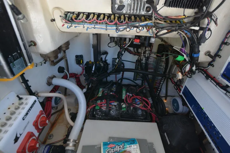 Hot Hooks II Yacht Photos Pics Engine compartment of a 2013 Contender 25 Bay boat, showcasing wiring and components.
