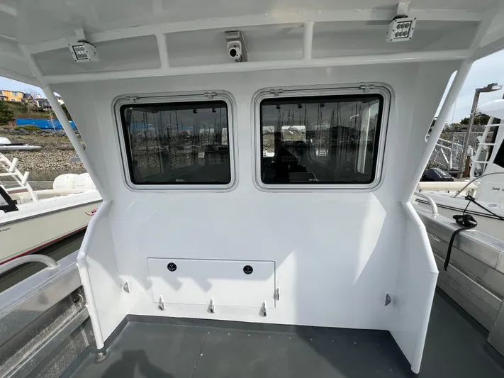  Yacht Photos Pics 2021 Velocity LC3311 boat cabin with dual windows, docked at marina.
