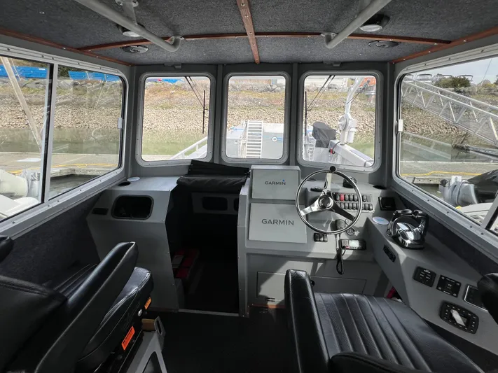  Yacht Photos Pics Interior of 2021 Velocity LC3311 boat with Garmin navigation system and steering wheel.