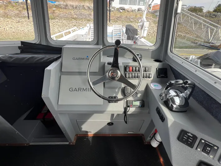  Yacht Photos Pics Interior of a 2021 Velocity LC3311 boat with Garmin navigation system and steering wheel.