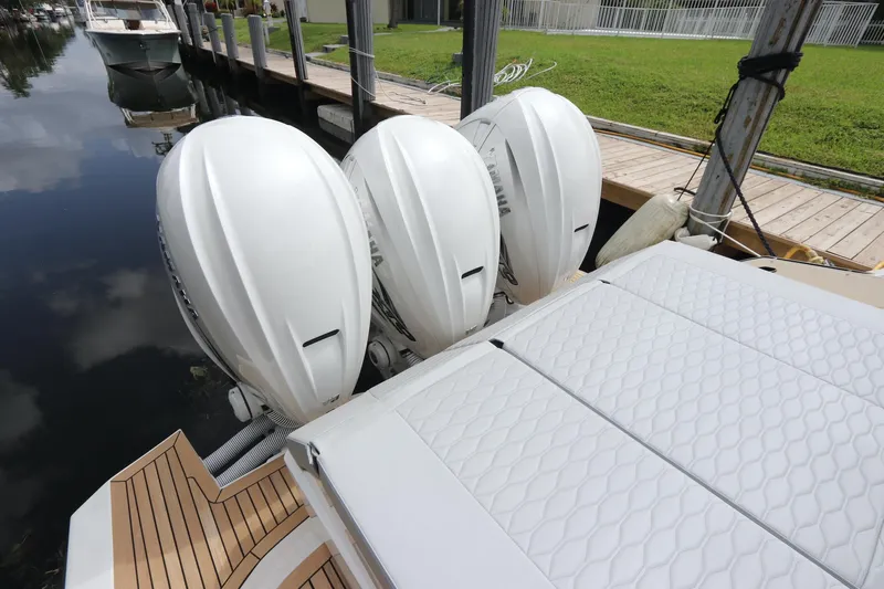  Yacht Photos Pics 2024 Astondoa 377 Coupe Outboard with triple engines docked by wooden pier.