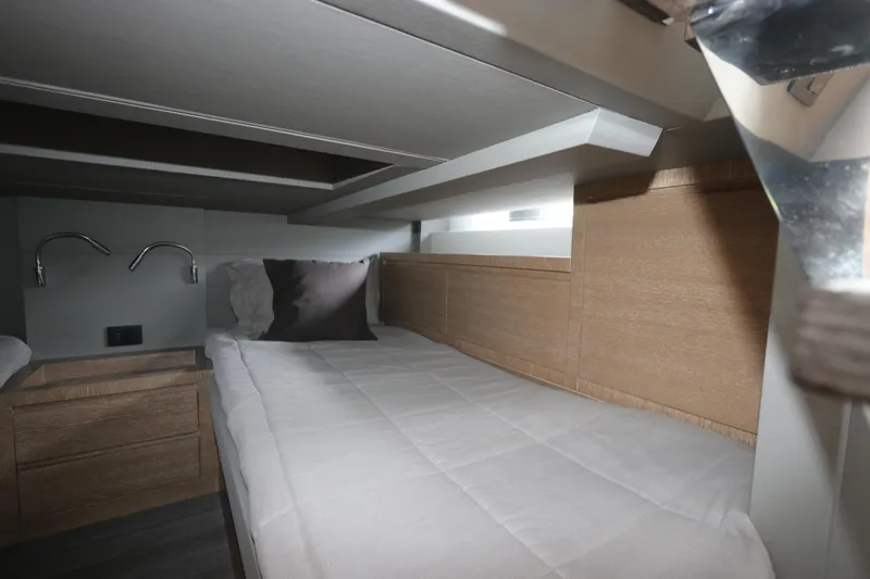  Yacht Photos Pics 2024 Astondoa 377 Coupe Outboard cabin interior with modern bedding and wood accents.