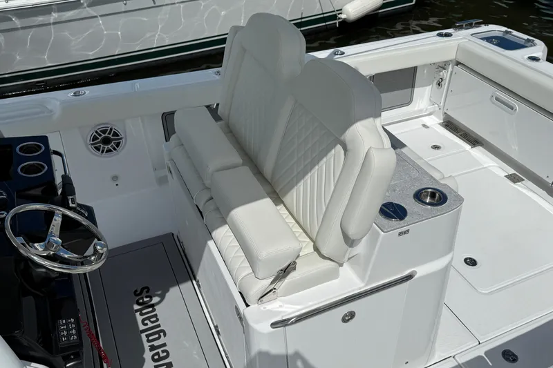  Yacht Photos Pics 2026 Everglades 315 Center Console boat interior with white seating and steering wheel.