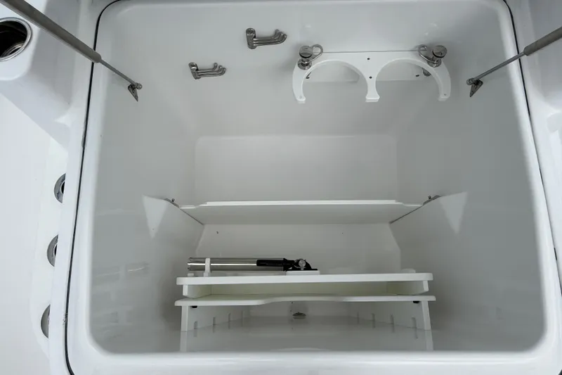  Yacht Photos Pics Storage compartment of 2026 Everglades 315 Center Console boat, featuring organized shelving.