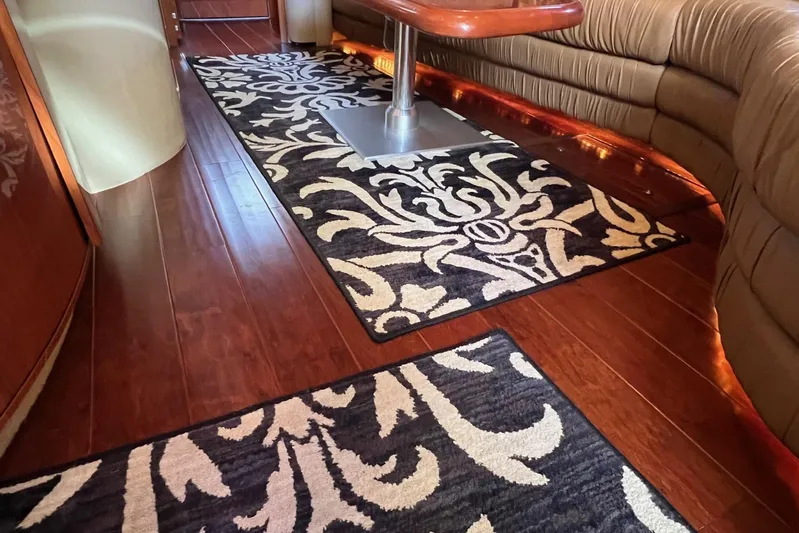  Yacht Photos Pics Luxurious interior of 1998 Sea Ray 540 Sundancer with elegant wood flooring and patterned rugs.
