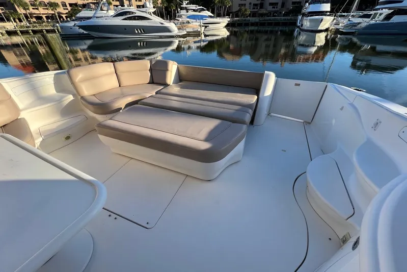  Yacht Photos Pics Spacious deck seating on 1998 Sea Ray 540 Sundancer yacht, docked in a serene marina.