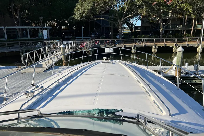  Yacht Photos Pics 1998 Sea Ray 540 Sundancer yacht docked at a marina with scenic surroundings.