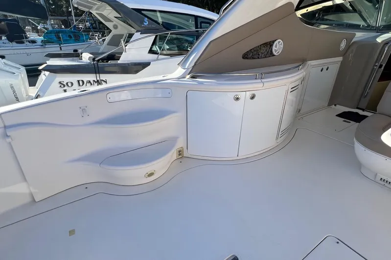  Yacht Photos Pics 1998 Sea Ray 540 Sundancer yacht interior with sleek white cabinetry and seating area.