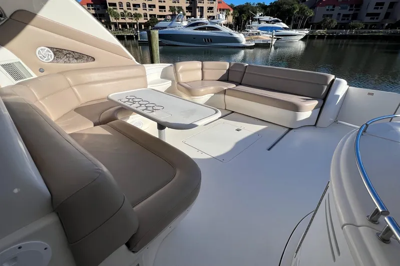  Yacht Photos Pics Luxurious seating area on a 1998 Sea Ray 540 Sundancer yacht, docked in a marina.