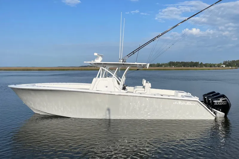  Yacht Photos Pics 2022 SeaHunter 33 Tournament boat on calm water, featuring twin outboard engines.